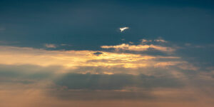 sun beams bursting through dark clouds